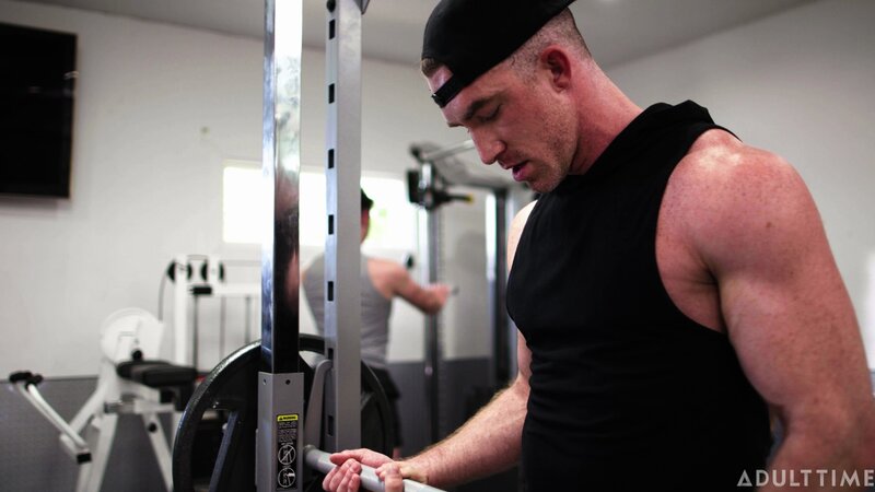 Personal trainer Nick Fitt gets real close to client Roman Todd at the gym