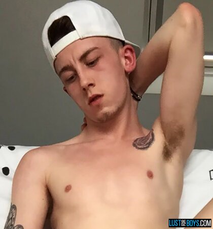 Arron Myers kicks back in his socks and strokes his big uncut cock