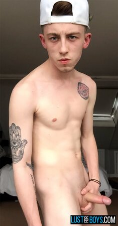 Arron Myers kicks back in his socks and strokes his big uncut cock