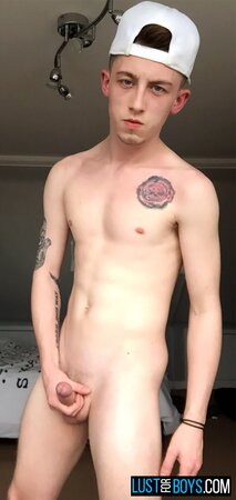 Arron Myers kicks back in his socks and strokes his big uncut cock