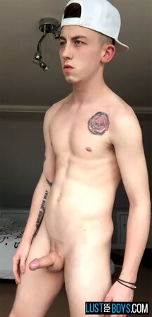 Arron Myers kicks back in his socks and strokes his big uncut cock