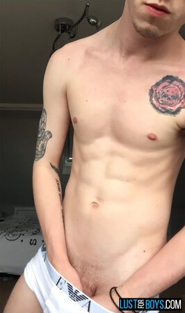 Arron Myers kicks back in his socks and strokes his big uncut cock