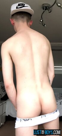 Arron Myers kicks back in his socks and strokes his big uncut cock