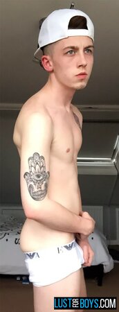 Arron Myers kicks back in his socks and strokes his big uncut cock
