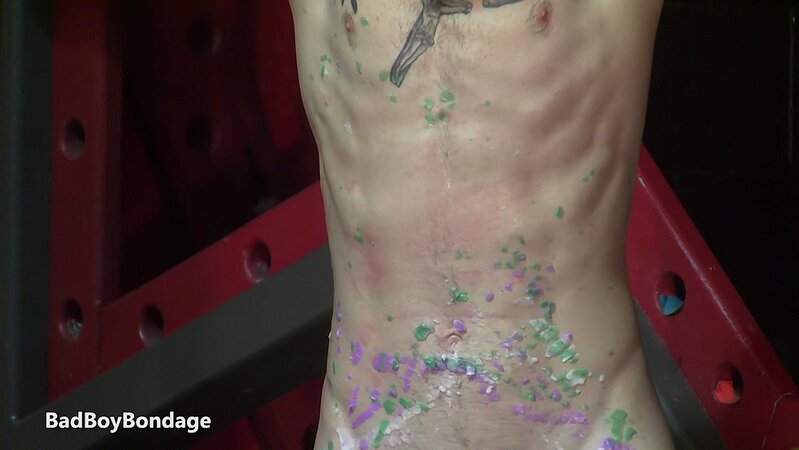 Mikeal flogs the hardened wax off Chad’s marked body while stroking his aching dick