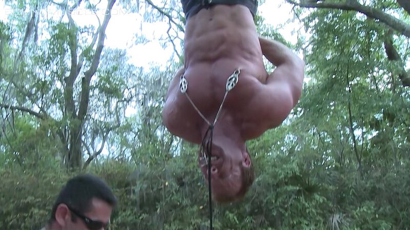 Derek Pain hangs upside down while Mulengro torments his sensitive nipples with heavy weights