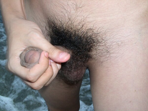 Young twink Adrial gets completely naked on the beach and strokes his cock