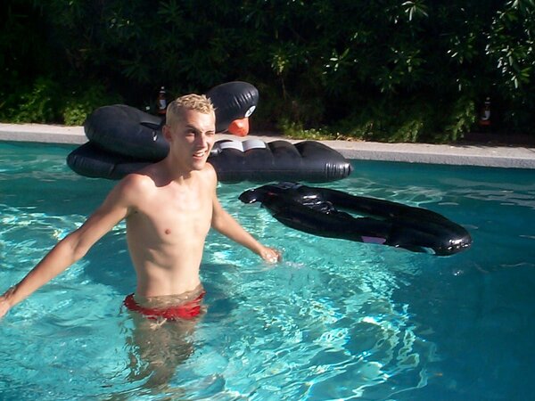 Sporty twink cools off in the pool after stroking by the water