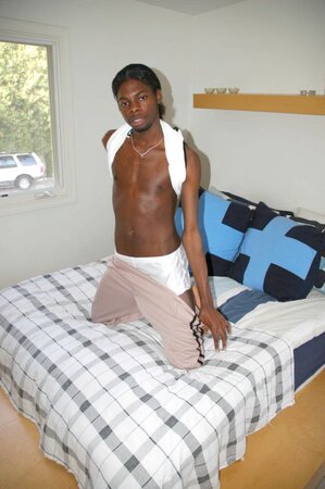 Black stud with a long uncut cock shows off his hot body