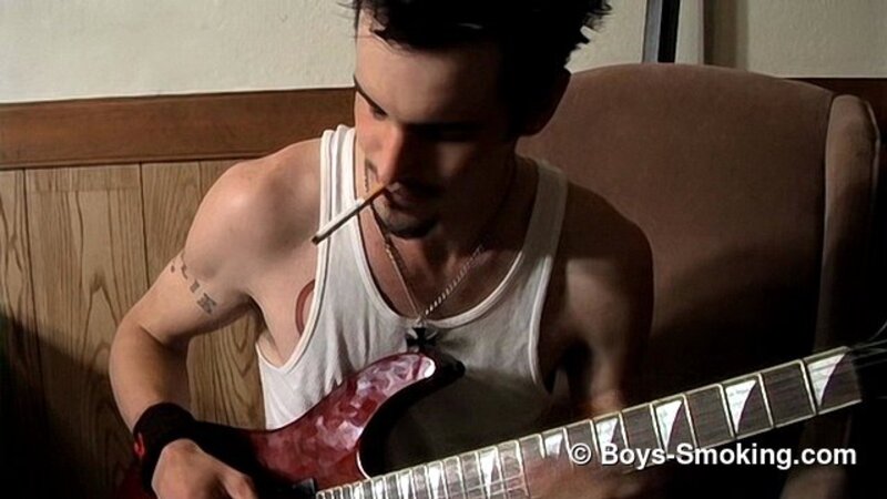 Rocker Axel smokes two cigarettes at once while playing guitar and jerking off