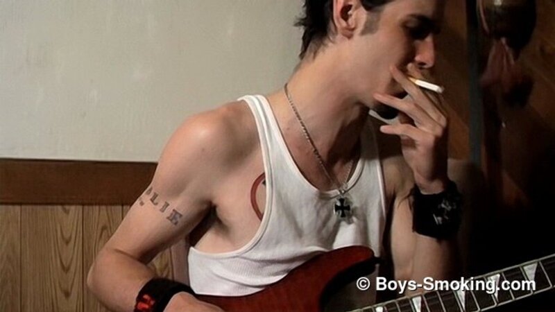 Rocker Axel smokes two cigarettes at once while playing guitar and jerking off