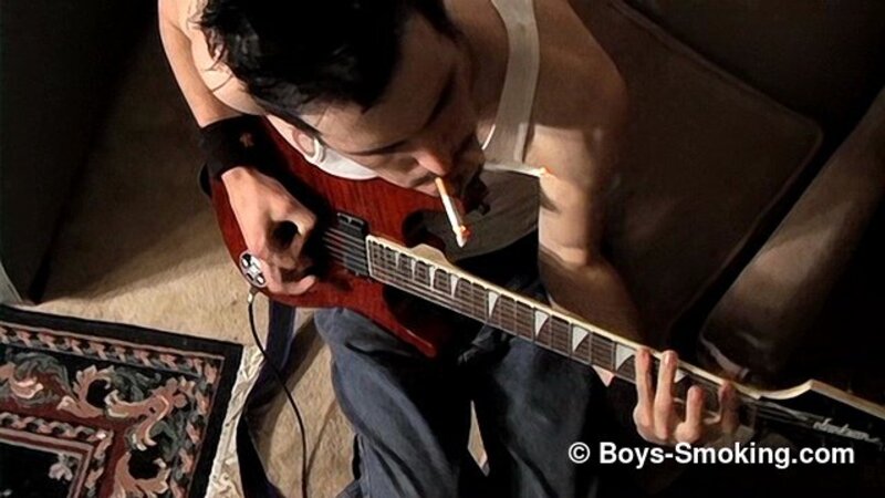 Rocker Axel smokes two cigarettes at once while playing guitar and jerking off