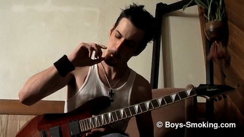 Rocker Axel smokes two cigarettes at once while playing guitar and jerking off