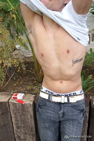 Dustin Fitch chainsmokes outdoors while stroking his big twink dick
