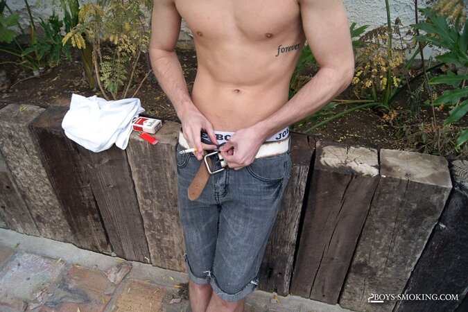 Dustin Fitch chainsmokes outdoors while stroking his big twink dick