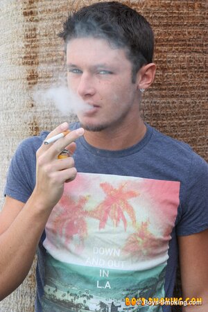 Smooth twink Damon Archer smokes and strokes outdoors in the backyard