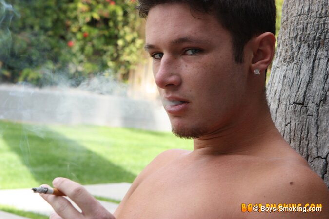 Smooth twink Damon Archer smokes and strokes outdoors in the backyard