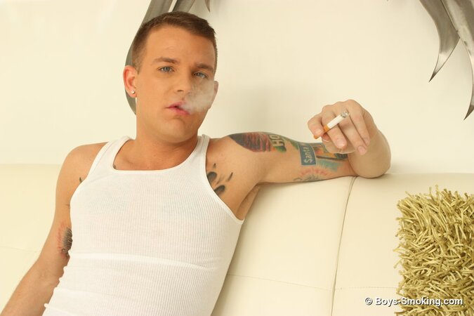 Brandon Wilde kicks back on the couch smoking and stroking his thick dick