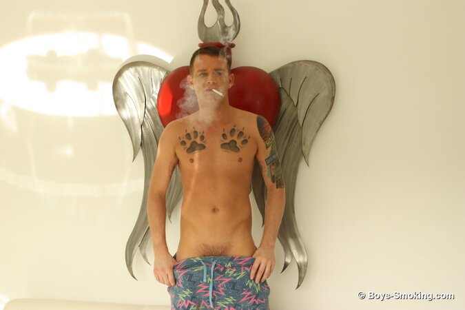 Brandon Wilde kicks back on the couch smoking and stroking his thick dick