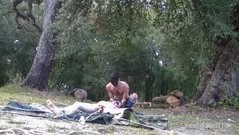 Dylan Frost ties up slim twink Jesse Lane for some intense outdoor BDSM