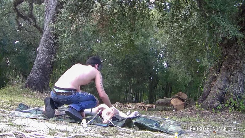 Dylan Frost ties up slim twink Jesse Lane for some intense outdoor BDSM