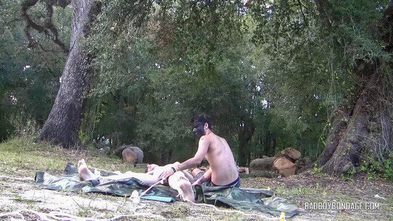 Dylan Frost ties up slim twink Jesse Lane for some intense outdoor BDSM