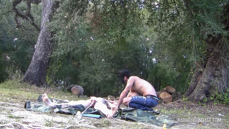 Dylan Frost ties up slim twink Jesse Lane for some intense outdoor BDSM