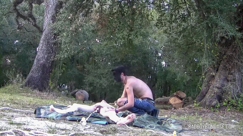 Dylan Frost ties up slim twink Jesse Lane for some intense outdoor BDSM