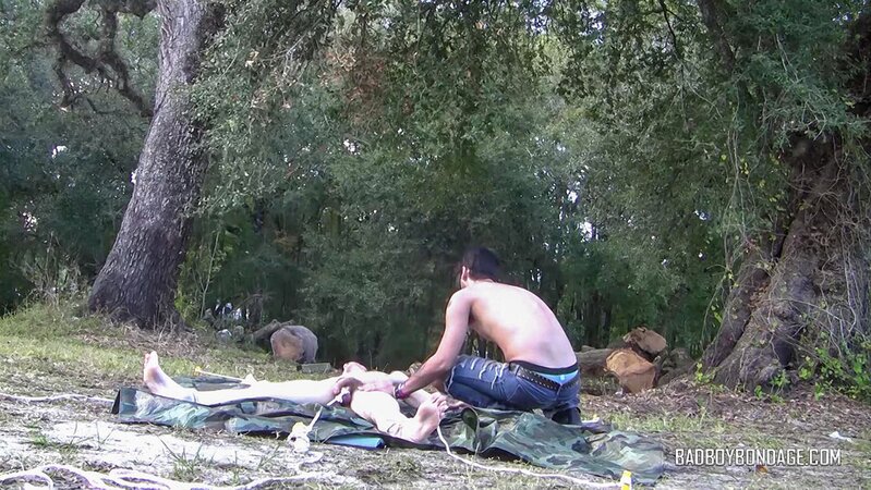 Dylan Frost ties up slim twink Jesse Lane for some intense outdoor BDSM