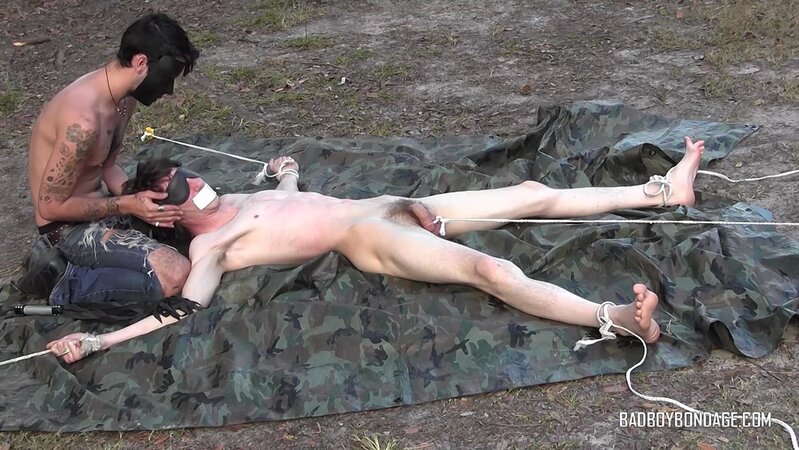 Dylan Frost ties up slim twink Jesse Lane for some intense outdoor BDSM