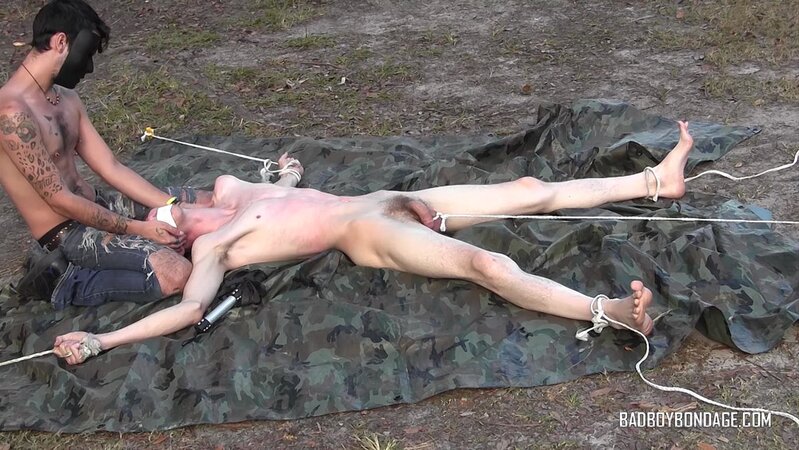 Dylan Frost ties up slim twink Jesse Lane for some intense outdoor BDSM