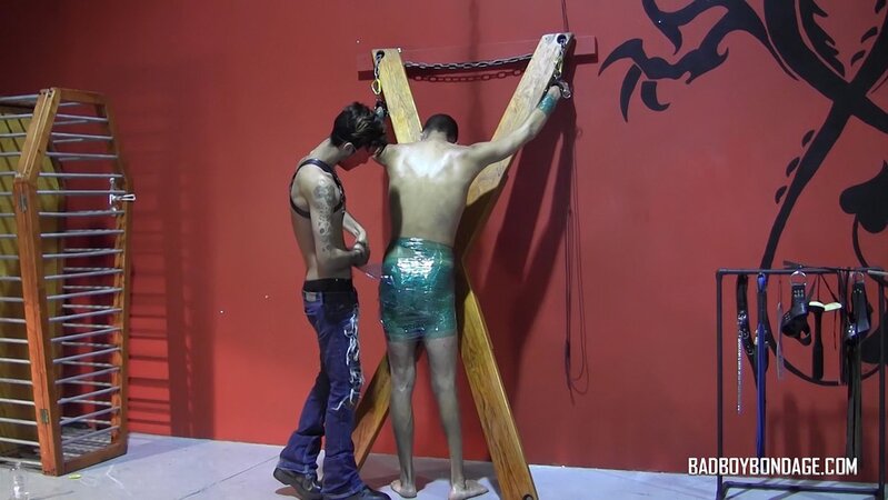 Masked master Ryann Ruckers spanks a defiant Justin Martinez with plastic