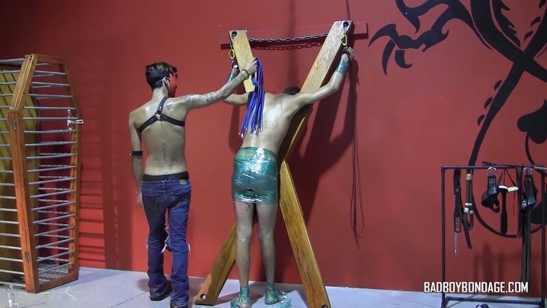 Masked master Ryann Ruckers spanks a defiant Justin Martinez with plastic