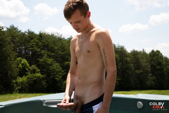 Cute twink JJ Jakobs shows off his massive cock in an outdoor hot tub
