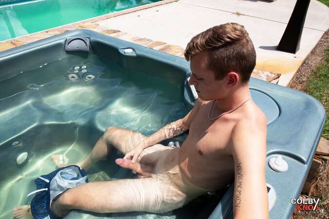 Cute twink JJ Jakobs shows off his massive cock in an outdoor hot tub