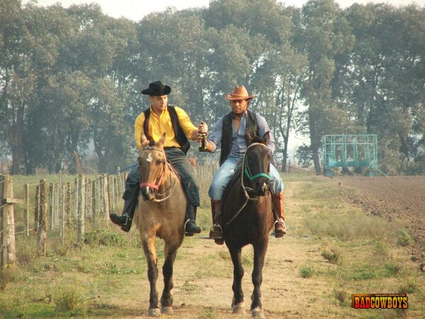 Two gay cowboys share skinny guy's ass