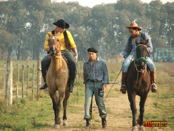 Two gay cowboys share skinny guy's ass