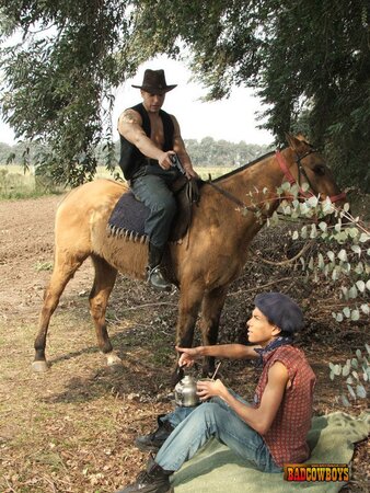 Slim guy bends over to take two cowboy cocks