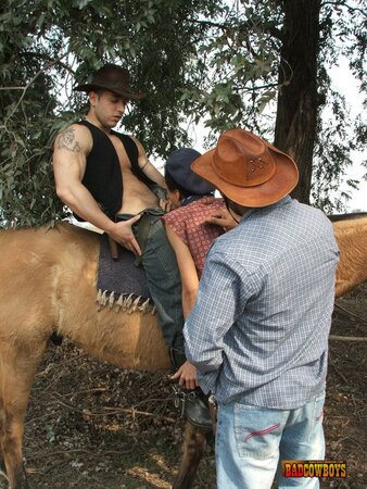 Slim guy bends over to take two cowboy cocks