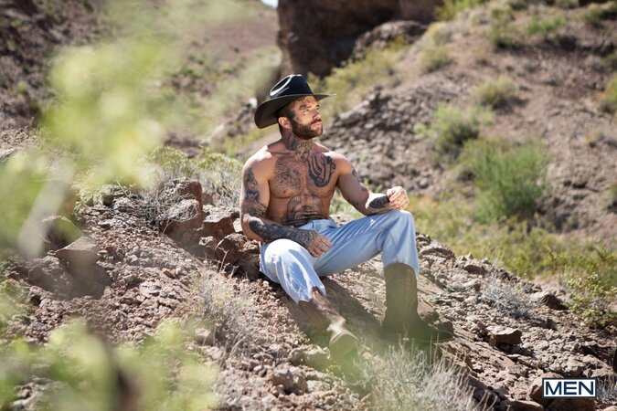 Cowboy Joel Hart drives into Sage Rouxe against the desert truck bed