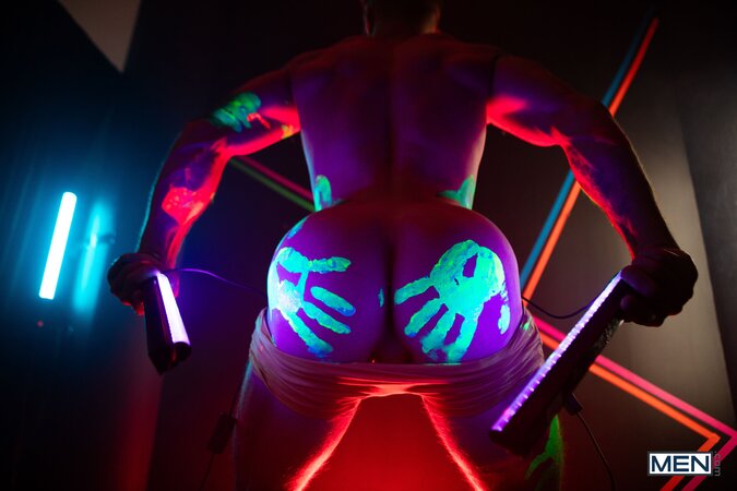 Theo Brady and Olivier Robert cover each other in neon paint during a rave fuck