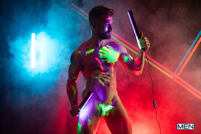Theo Brady and Olivier Robert cover each other in neon paint during a rave fuck