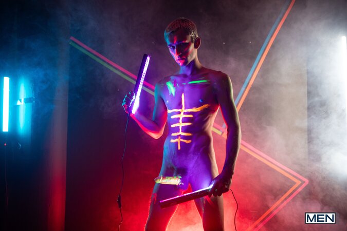 Theo Brady and Olivier Robert cover each other in neon paint during a rave fuck