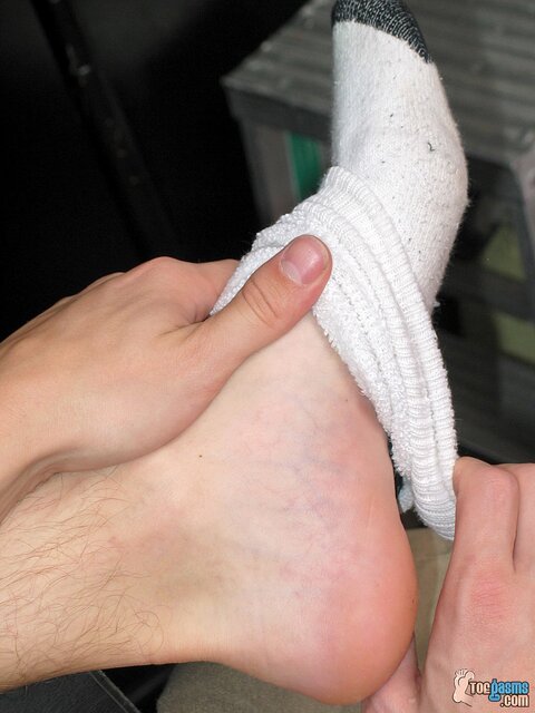 Ian Madrox shows off his socks and feet