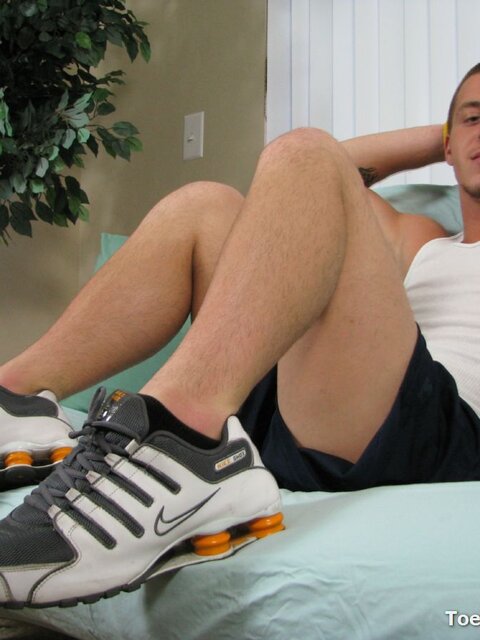 Travis Cooper plays with his feet and cock