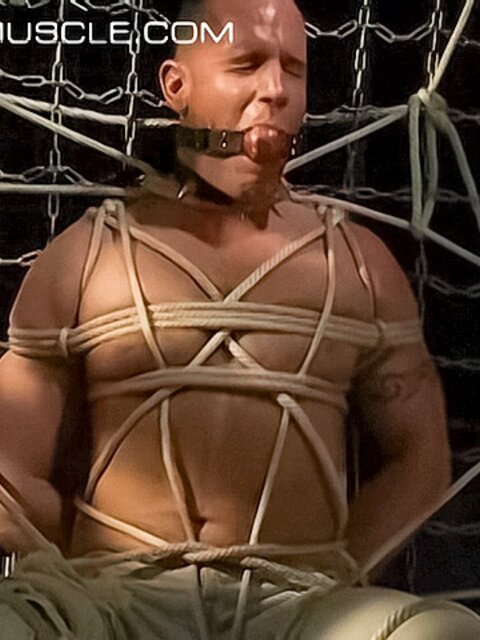 Bound Bigg Pete can't speak with a ball gag in his mouth