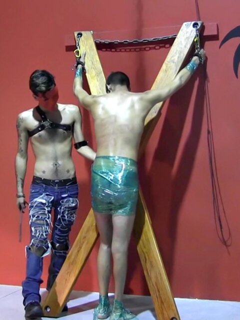 Ryann Ruckers torments Justin Martinez on the bondage cross