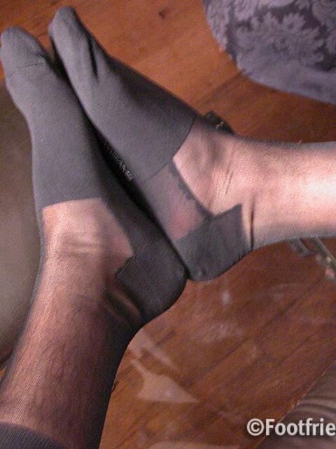 Jonathan shows off his business chic style with sheer socks and size 11 feet