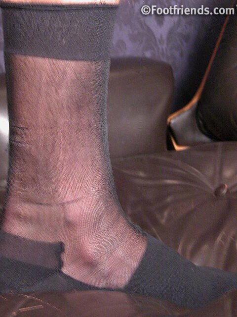 Jonathan shows off his business chic style with sheer socks and size 11 feet