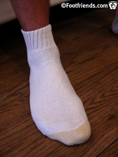 Dean Edwards models his size 11EE feet in white and black socks